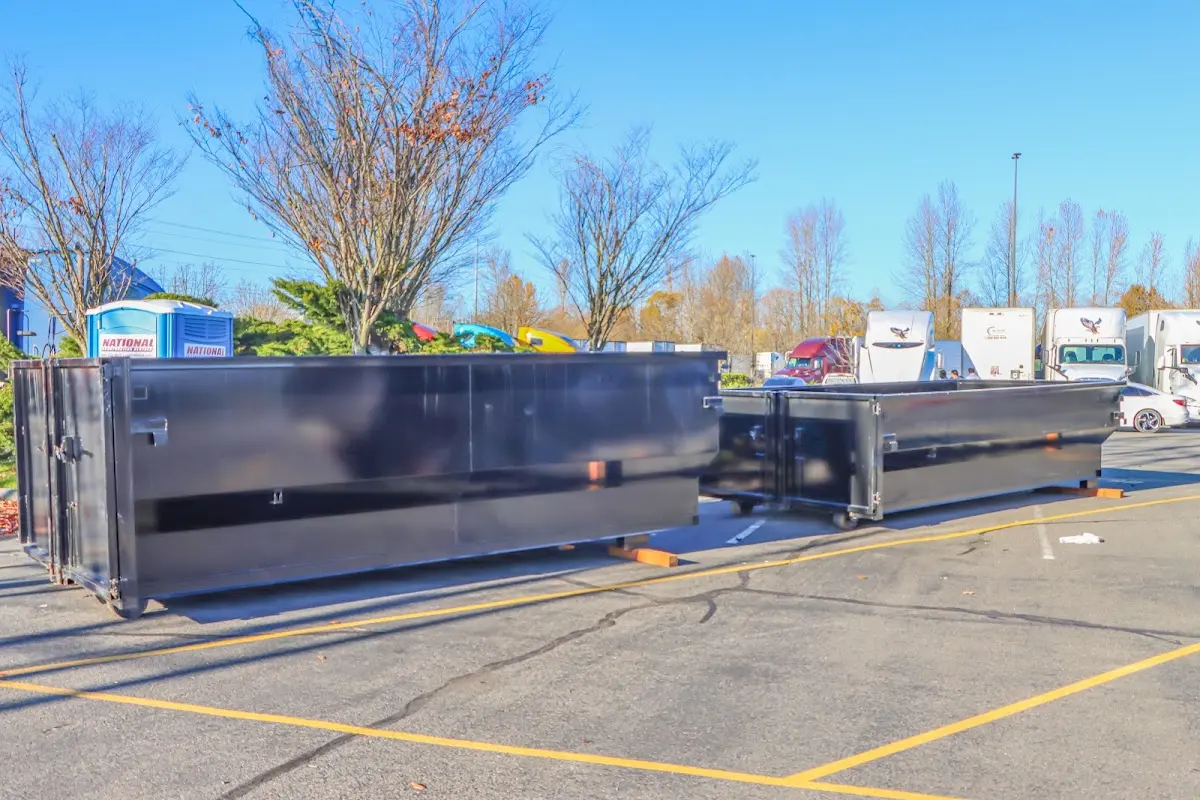 Professional dumpster rental service with roll-off container on residential driveway in Baldwin City